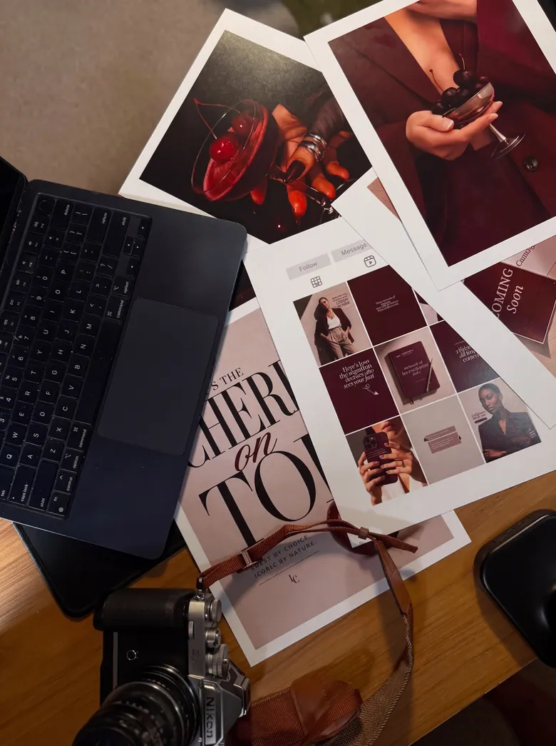 A laptop, printed Morello brand collateral and a film camera on a desk