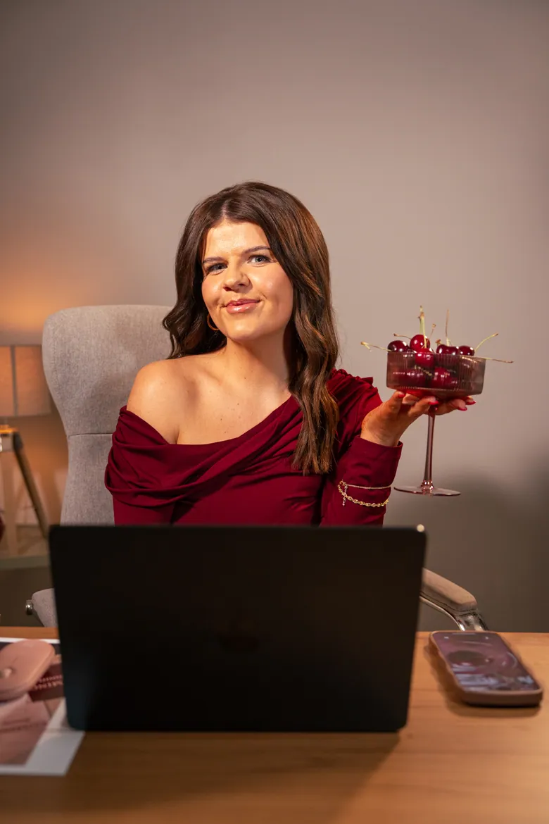 Molly Green holding a coupe glass of cherries